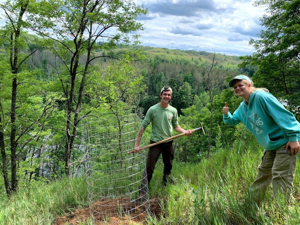 Two EcoCorps team members work to prevent erosion on the Manistee river in Northern Michigan.